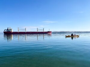 freighter and kayak on lake