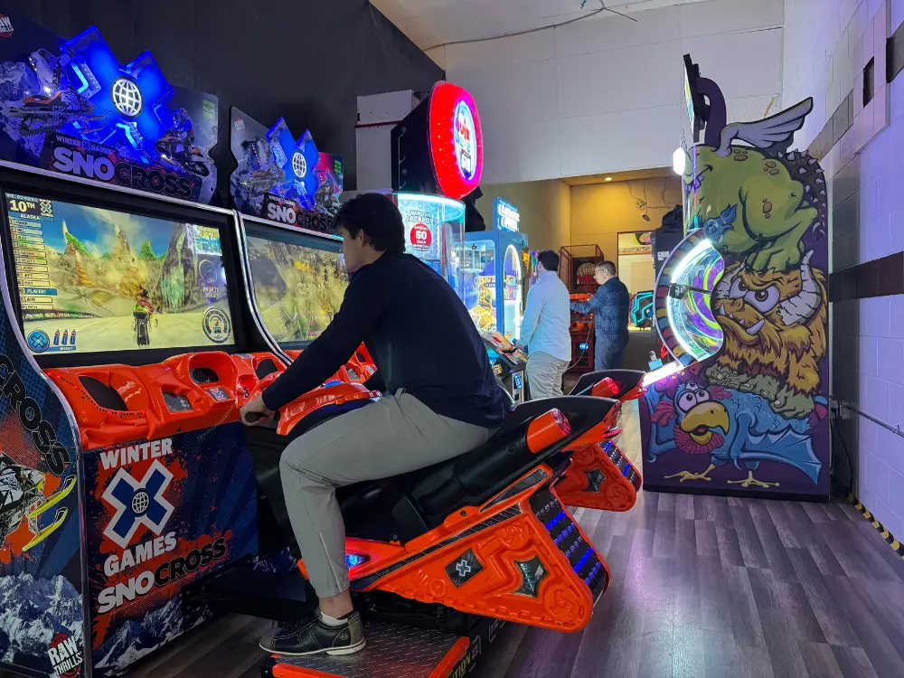 Dragon’s Lair Arcade Young boy riding an arcade motorcycle at Dragon's Lair Arcade